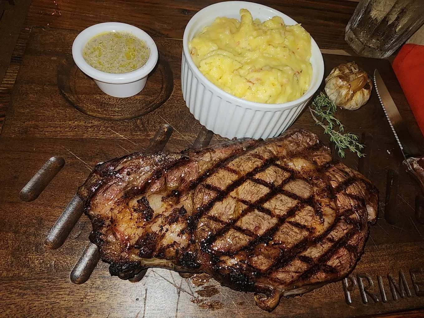 Grilled ribeye with mashed potatoes and roasted garlic